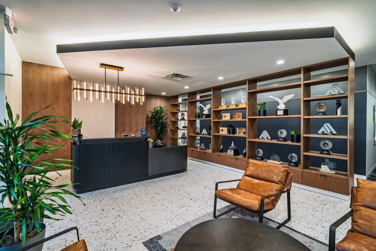 Modern corporate reception with custom desk, feature wall, and display cabinetry