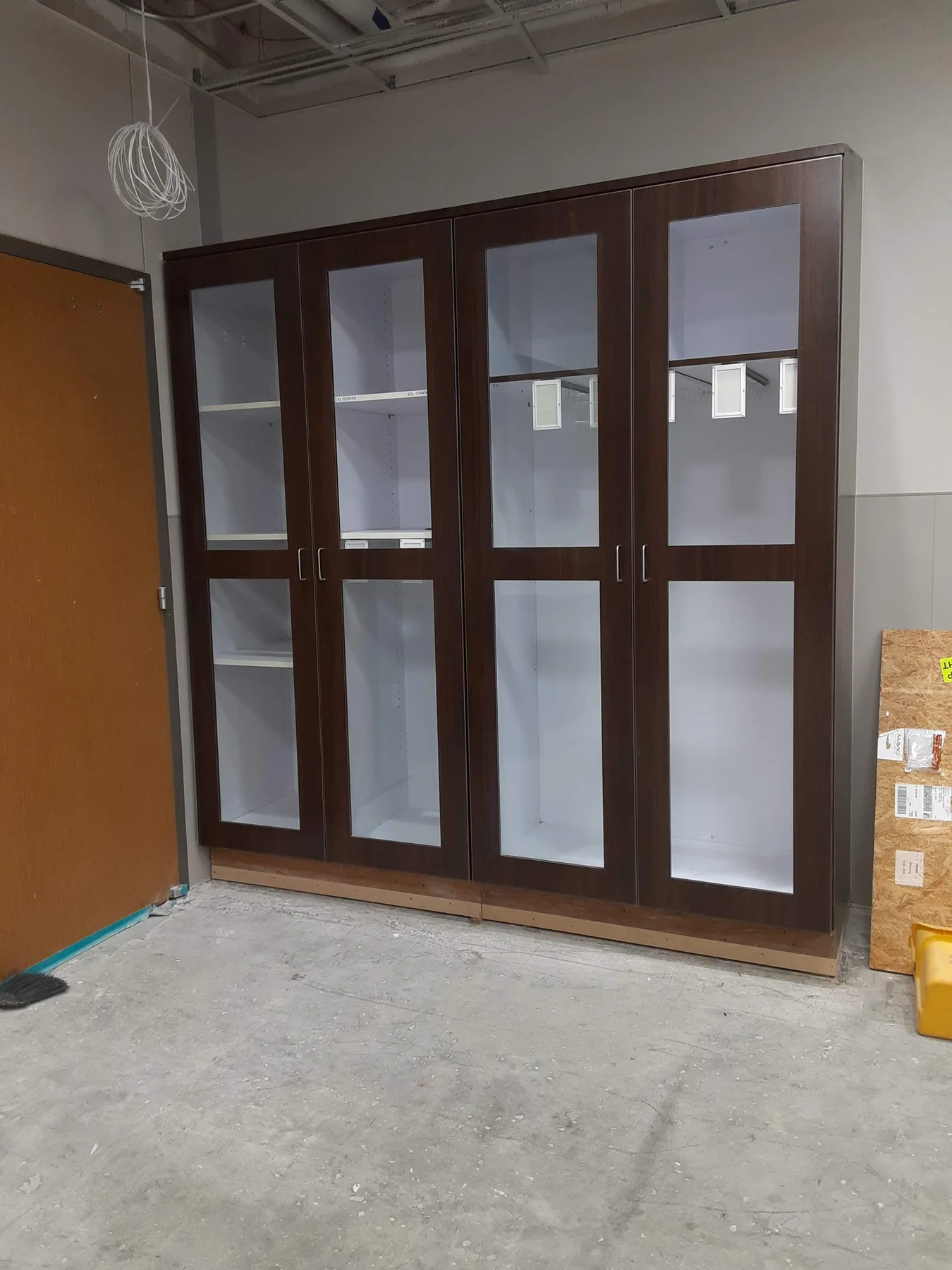 Tall dark wood glass-front commercial storage cabinets