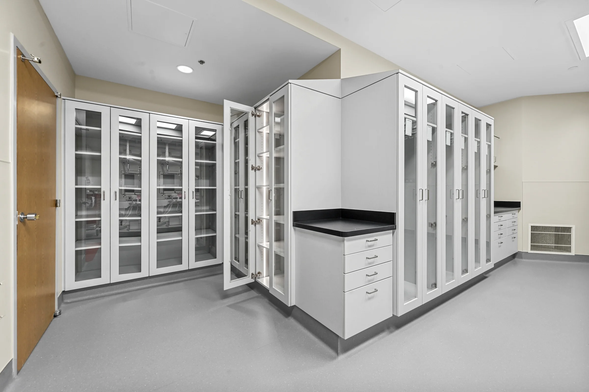 Completed healthcare casework with glass-front storage and work surfaces