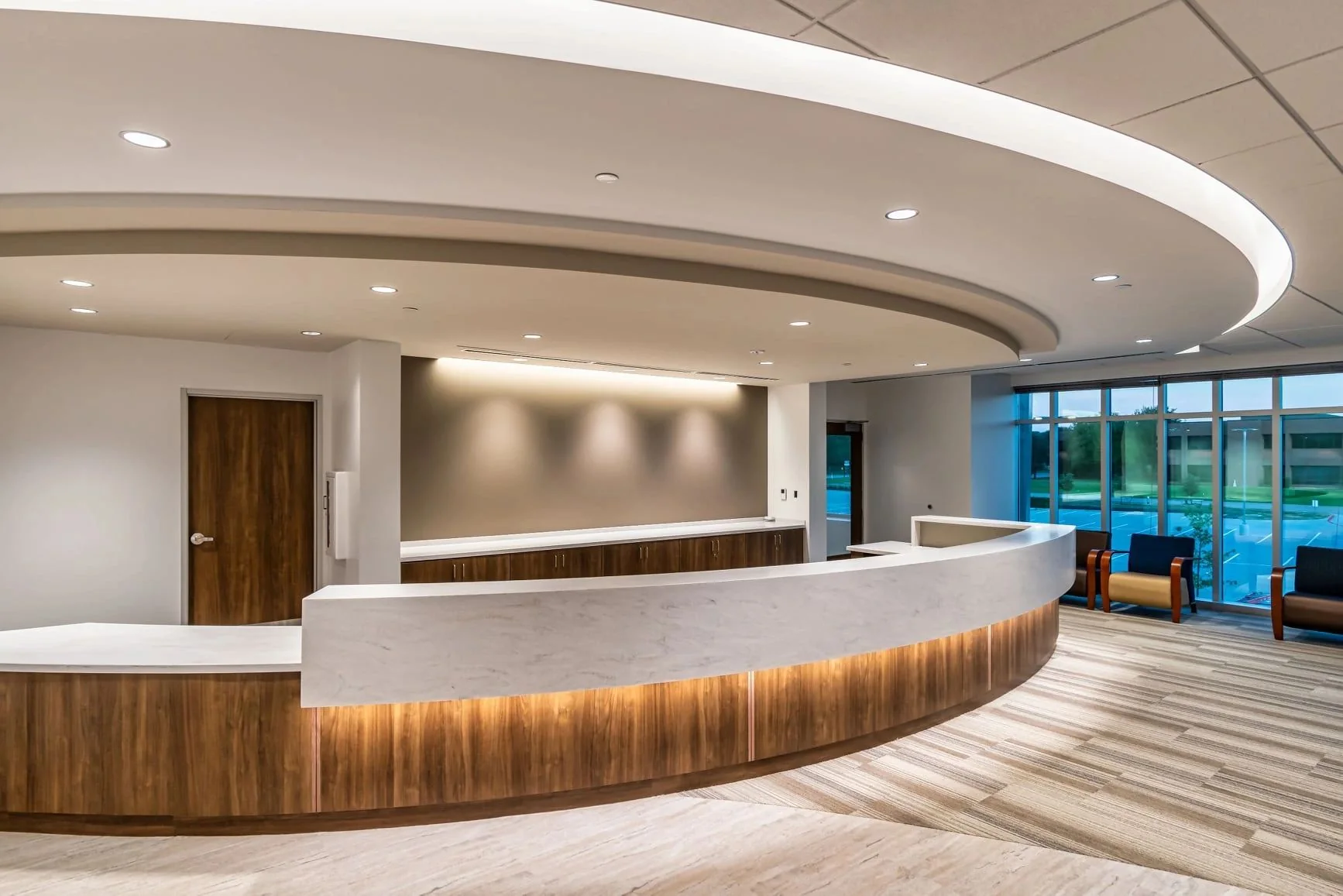 Curved custom reception desk and architectural millwork by Boese Millworks